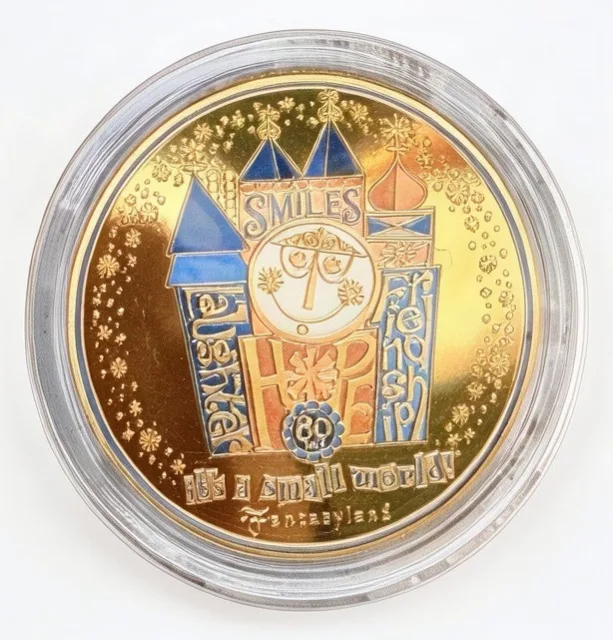 it's a small world 60 Years Disney medallion coin, front (D23 Day event machine, D23 Day at Disneyland 2026)
