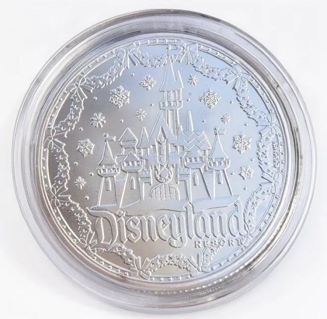 The Disneyland Resort at Christmas back of a Disney medallion coin (Minnie's Gift to Mickey)